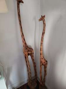 Decorative giraffes. Wood. One is about 5 ft, the other 4 ft. 
