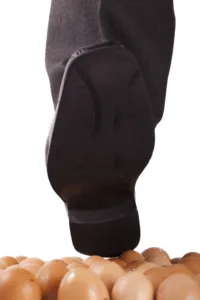 large boot stepping on an egg